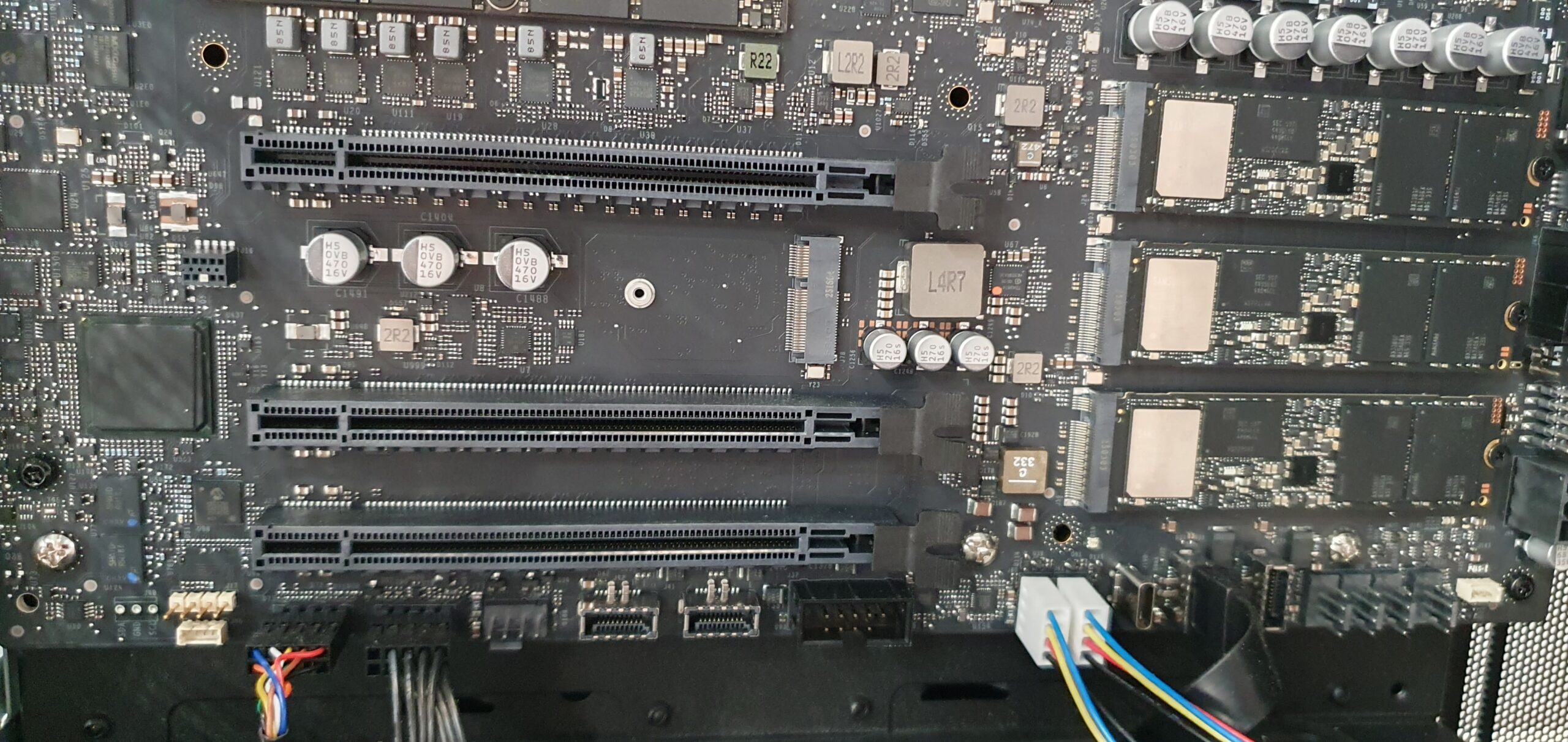 Close-up of a workstation motherboard showing PCIe expansion slots and M.2 NVMe modules — Gigabyte W775-V10-L01 NVIDIA DGX Station GB300