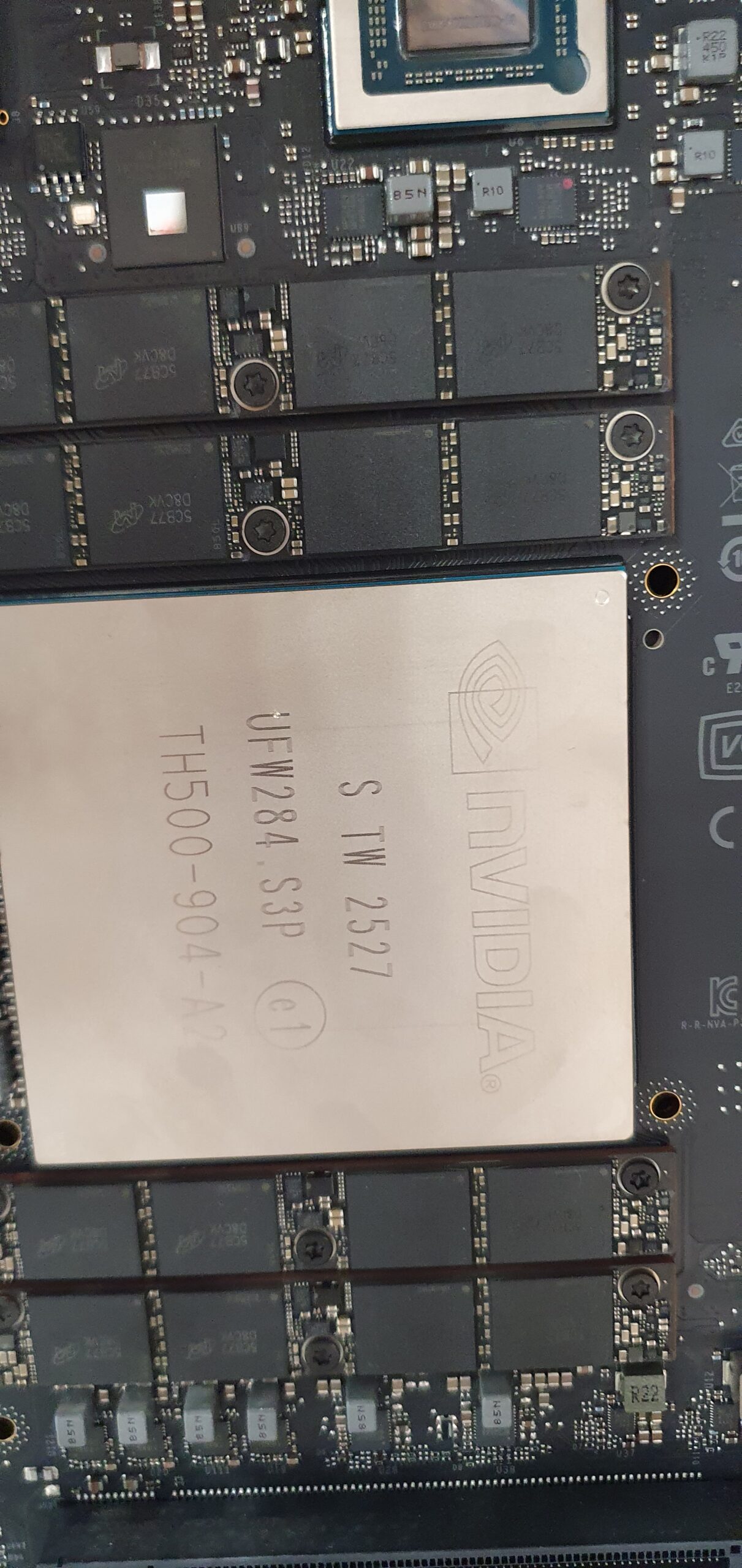 Close-up of an NVIDIA chip labeled TH500-904-A2 mounted on a circuit board with memory modules — Gigabyte W775-V10-L01 NVIDIA DGX Station GB300