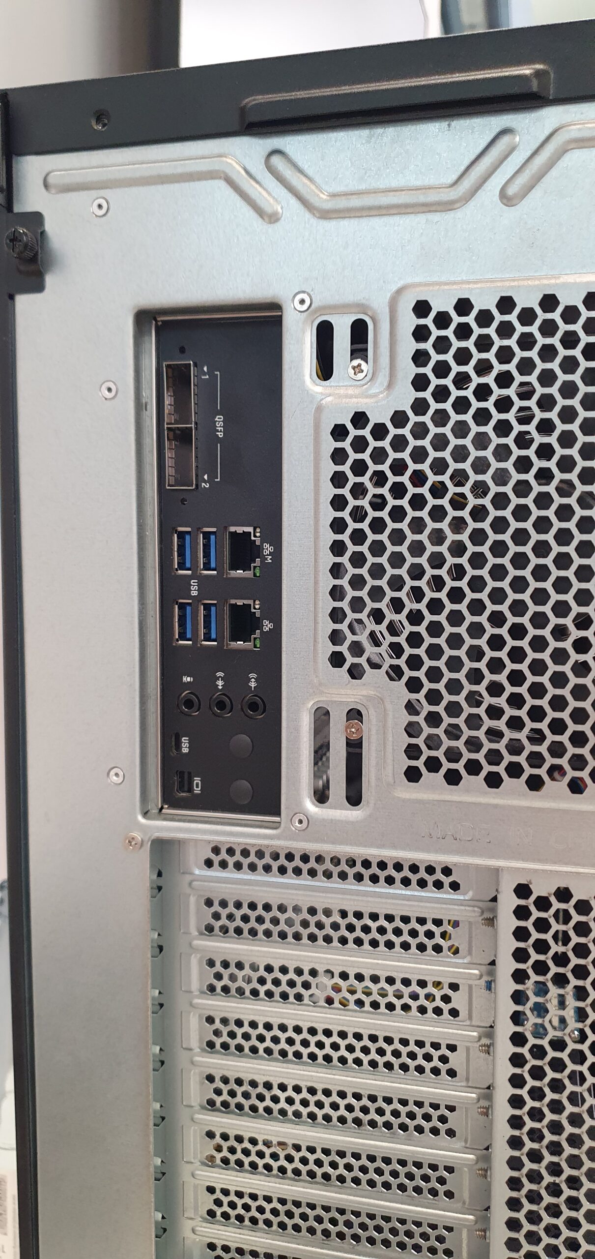 Close-up of a workstation rear I/O panel with QSFP network ports, USB and Ethernet connectors — Gigabyte W775-V10-L01 NVIDIA DGX Station GB300