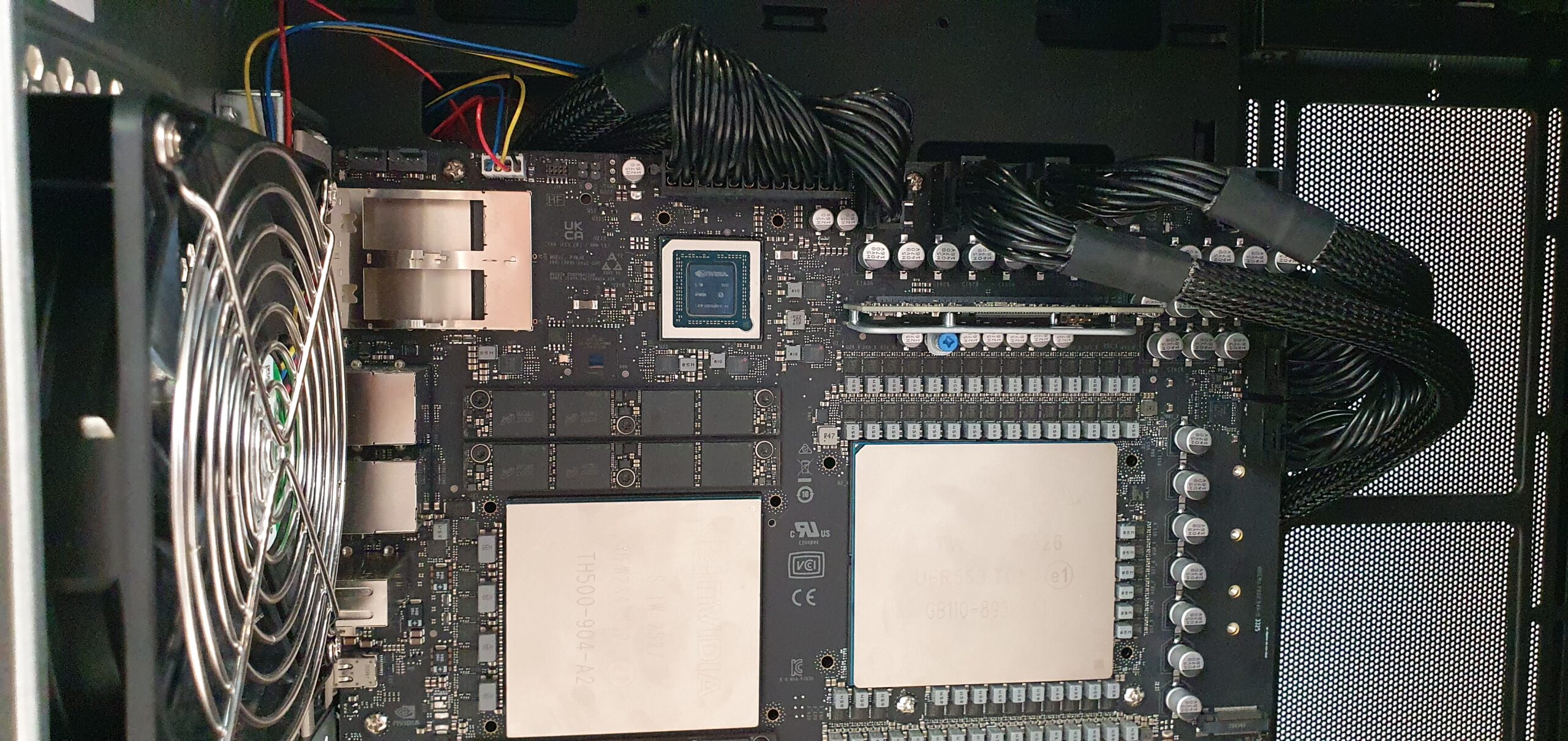 Open workstation chassis showing motherboard with large processor packages, cooling fan, and cabling — Gigabyte W775-V10-L01 NVIDIA DGX Station GB300