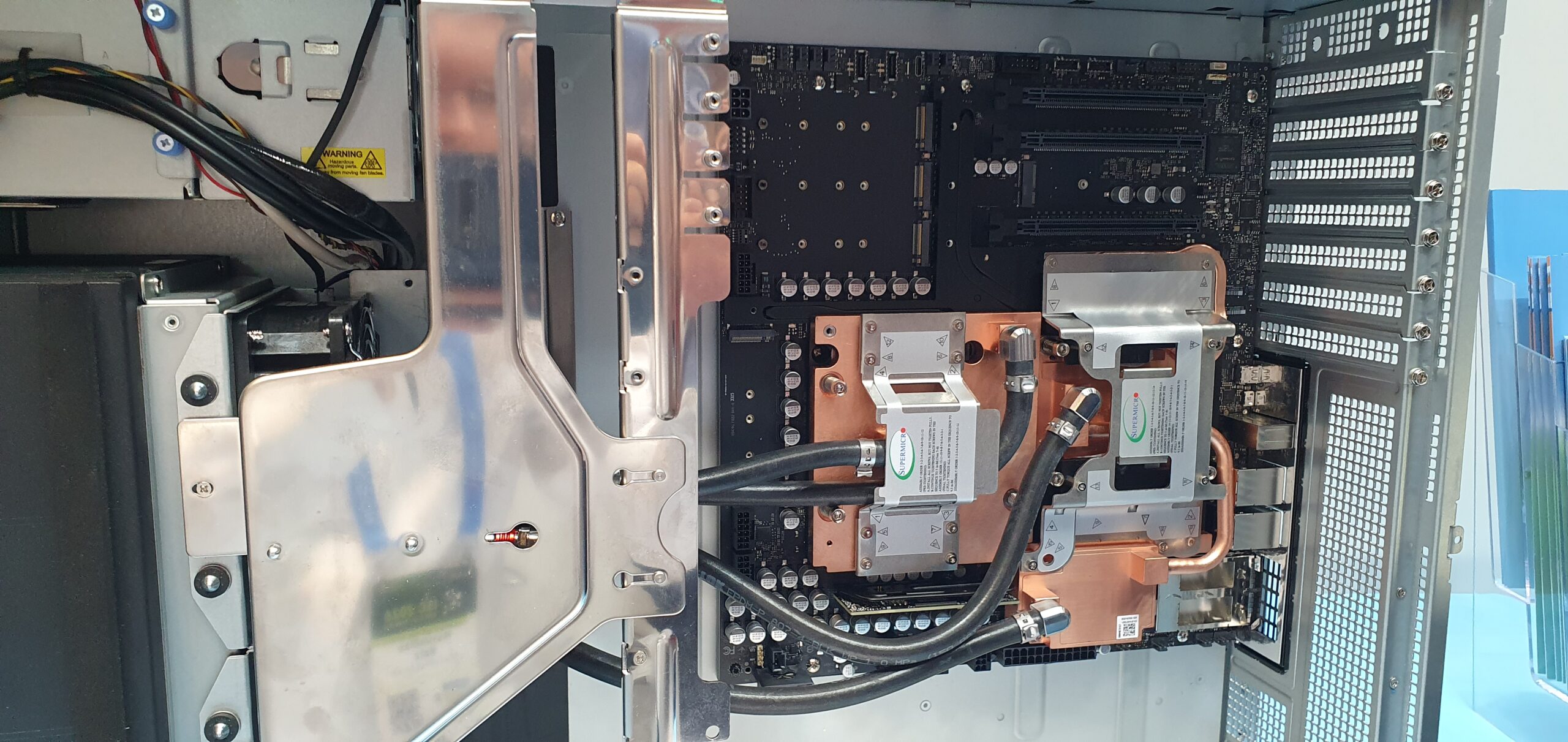 Open workstation chassis showing copper liquid cooling cold plates and tubing on motherboard — Supermicro ARS-511GD-NB-LCC NVIDIA DGX Station GB300