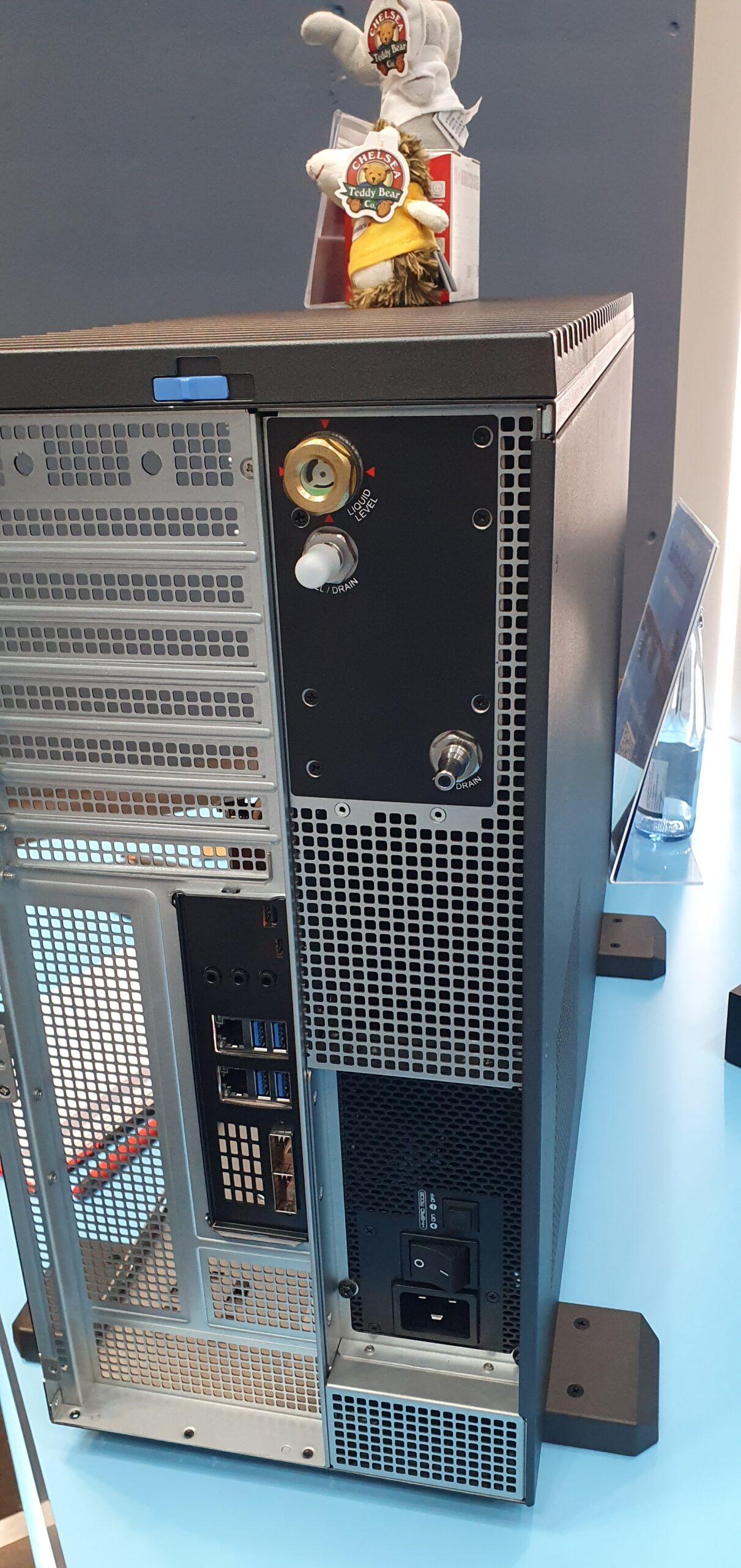Rear panel of a tower workstation chassis showing liquid cooling drain valves and fill port — Supermicro ARS-511GD-NB-LCC NVIDIA DGX Station GB300