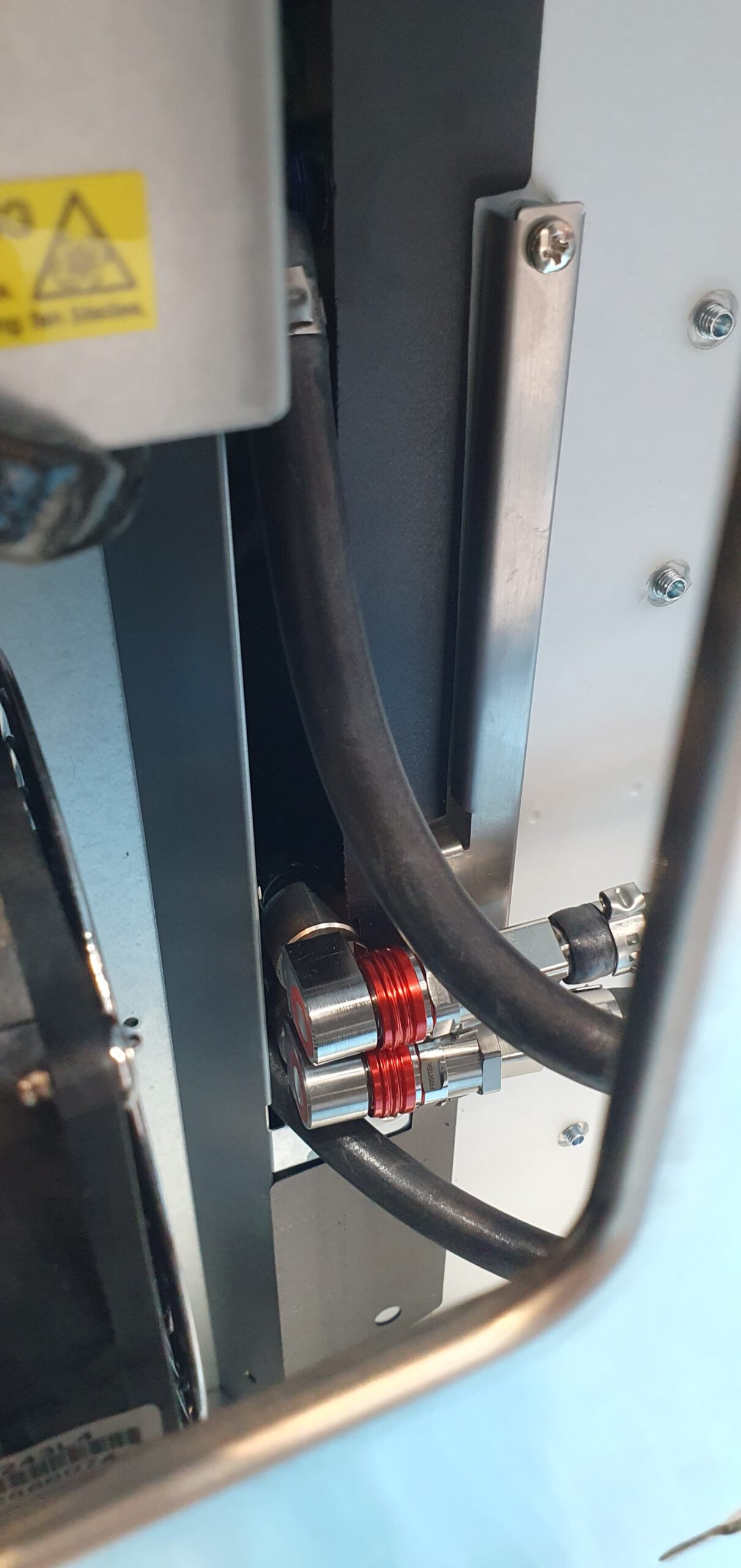 Close-up of red-collared quick-disconnect liquid cooling fittings inside a workstation chassis — Supermicro ARS-511GD-NB-LCC NVIDIA DGX Station GB300