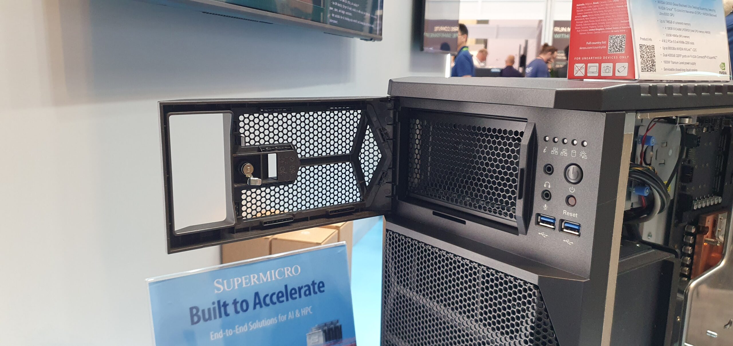 Supermicro tower workstation with open front door showing ports and mesh panel at trade show — Supermicro ARS-511GD-NB-LCC NVIDIA DGX Station GB300