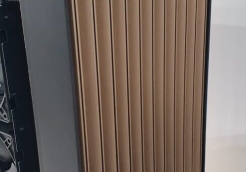 Gigabyte tower chassis with gold-toned ribbed side panel on display — Gigabyte W775-V10-L01 NVIDIA DGX Station GB300